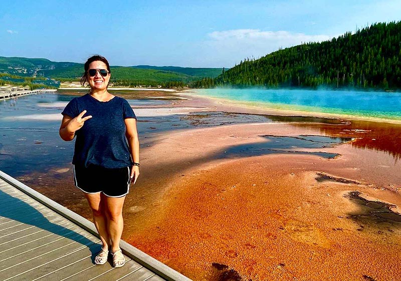 Rene Cizio, Microsoft Advertising Content Marketer and full-time digital nomad, stands by a hot springs.